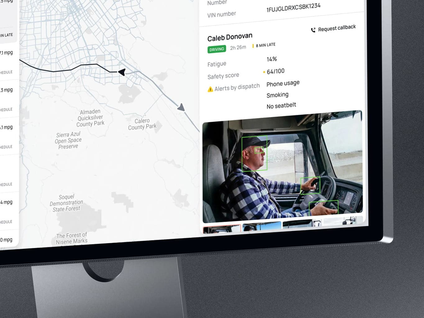 A fleet manager reviewing data on a laptop