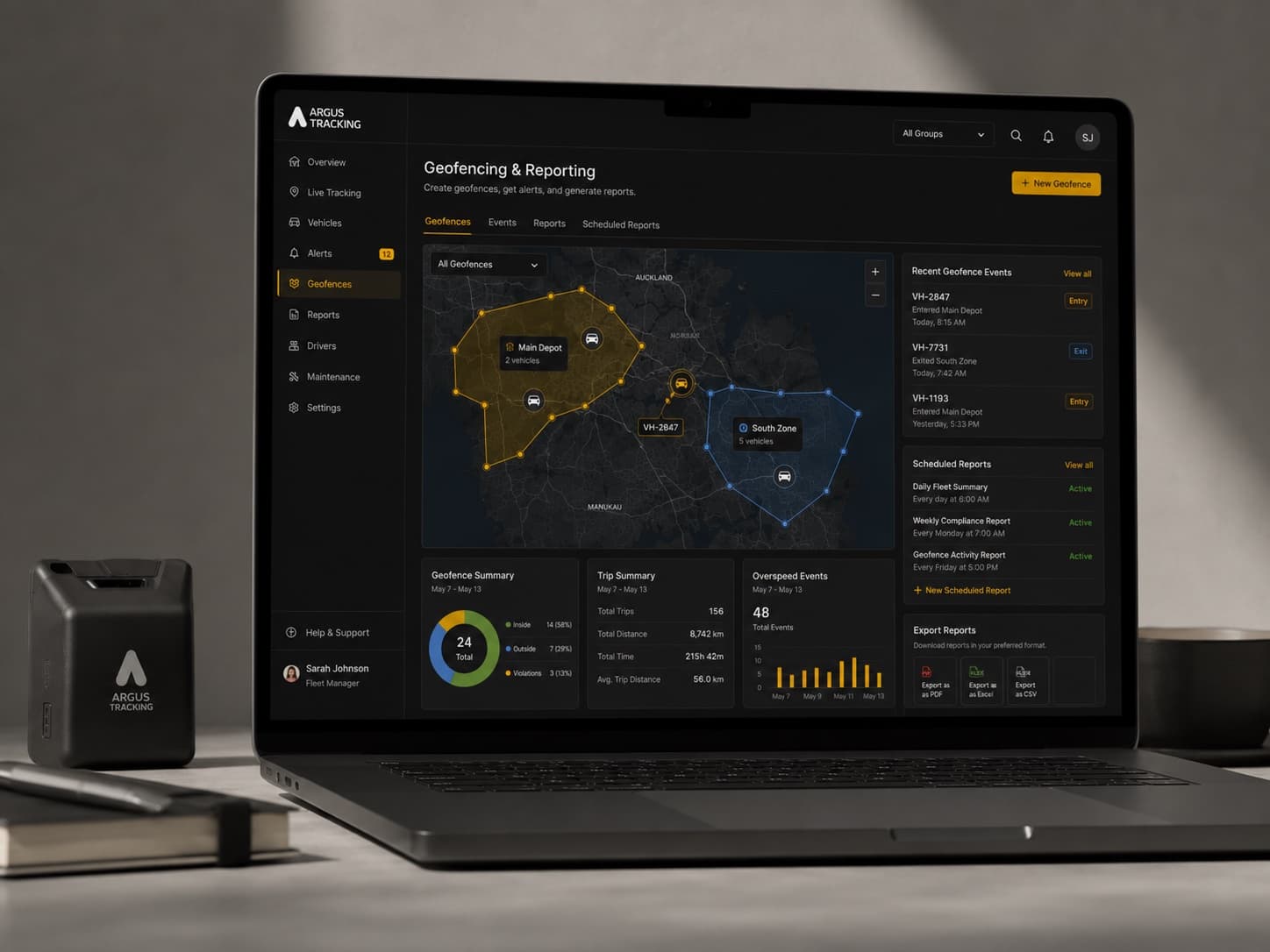The Argus GPS tracking device beside a laptop showing the geofencing and reporting dashboard